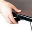 Hand positioning on black pneumatic adjustment hardware along table edge