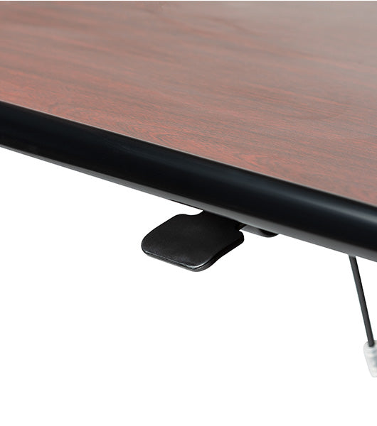 Wood grain tabletop edge detail showing black trim border and pneumatic adjustment hardware underneath table surface