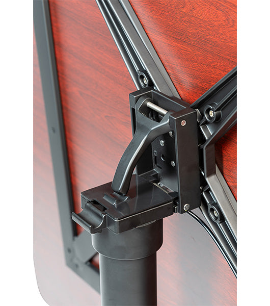 Tilting table mechanism detail showing black metal hinge and support bracket connecting to wooden tabletop surface