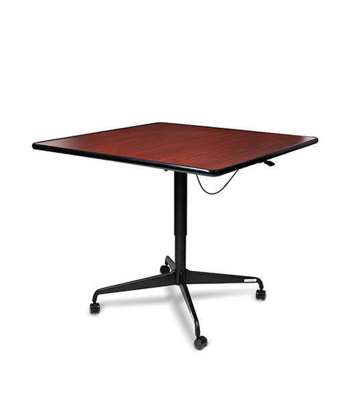 Square tilt top dining table featuring Mahogany wood grain surface with black metal base and four wheel casters