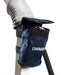 A blue fabric pouch labeled CHARGER is attached with Velcro straps to the white tube of the Free Spirit Bariatric Patient Lift FS660-T. The open flap reveals a charging cable inside.