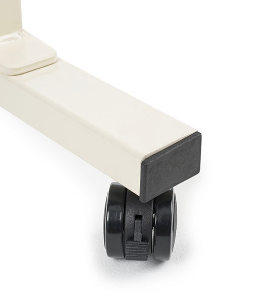 Close-up detail of white table leg with black wheel caster attachment
