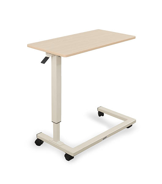 Overbed table for assisted living furniture featuring Maple surface with white height-adjustable base and four-wheel caster system