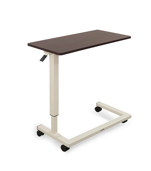 Overbed table for assisted living furniture featuring Mahogany surface with white height-adjustable base and four-wheel caster system