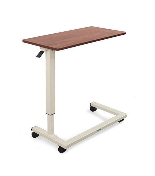 Overbed table for assisted living furniture featuring Amber Cherry surface with white height-adjustable base and four-wheel caster system
