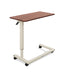 Overbed table for assisted living furniture featuring Amber Cherry surface with white height-adjustable base and four-wheel caster system