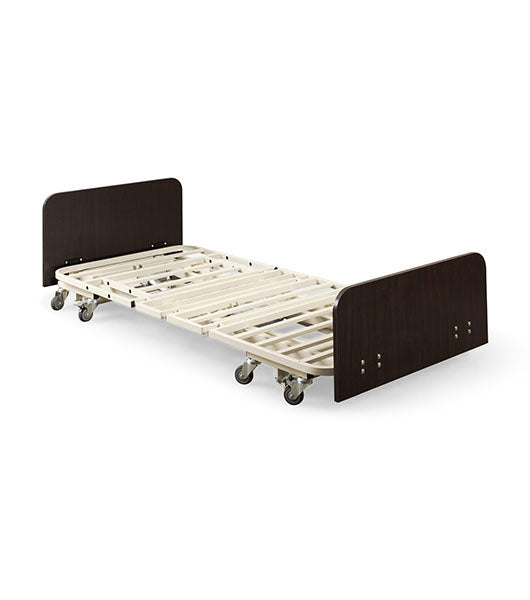 Ultra Low Adjustable Electric Hospital Bed (Medacure ULB7/30) frame shown in the flat, lowest position, featuring mahogany head and footboards and individual caster wheels without a visible central locking system