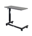Overbed table for assisted living furniture featuring Coastal Grey surface with black height-adjustable base and four-wheel caster system