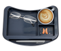 A close-up, top-down view of the organizer tray for an Icare over-bed table. The tray has four compartments: a large one holding a pair of eyeglasses, a medium one holding a cup of latte, a smaller one containing a pair of hearing aids, and a long groove at the bottom of the tray.