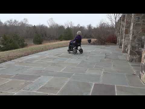 A video showcasing an elderly woman riding the Journey Air Elite Power Chair outdoors.