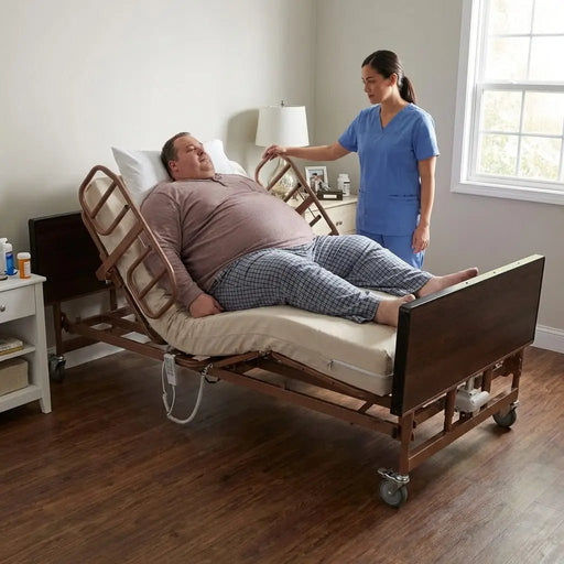 Bariatric patient seated upright on Proactive Protekt Akra Bariatric™ 48-inch full electric bed with half rails, assisted by caregiver during head elevation adjustment in home care setting.