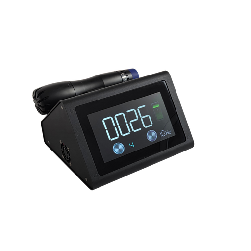 A side-angled view of the Radialspec Neo. The device is a compact, black wedge-shaped unit featuring a large digital display showing "0026," a frequency setting of "10Hz," and a green battery indicator. A black handpiece with a blue applicator tip is docked horizontally on the top-rear cradle. This angle highlights the cooling fan vent on the side panel and the sleek, matte black finish.
