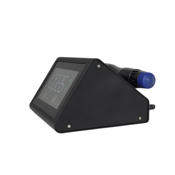 A side profile view of the Radialspec Neo, showing the triangular shape of the base and the silver assembly screws. A black handpiece with a blue applicator tip is docked horizontally on the top-rear cradle.