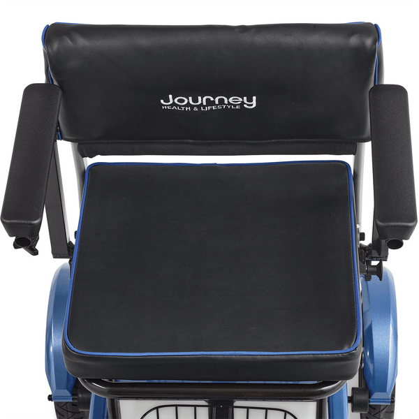 A top-down view of the scooter's seating area. It shows a wide, black padded seat with blue trim and a matching backrest featuring the "Journey Health & Lifestyle" logo. Two sturdy, padded armrests are positioned on either side.