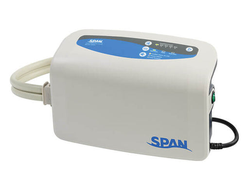 A studio shot of the SPAN digital control unit. It is a compact, off-white rectangular device with a blue interface panel on top featuring LED indicators for "Alternating," "Lateral," and "Static" modes, as well as a "Low Pressure" alarm.