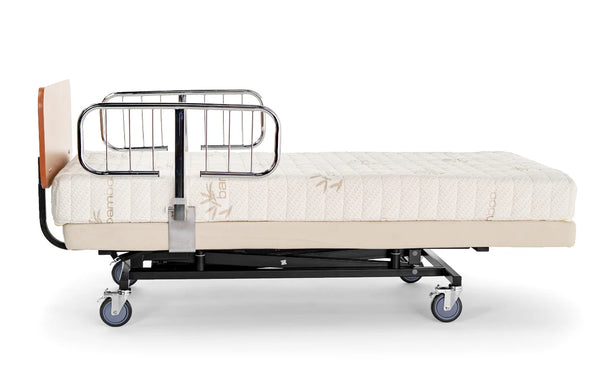 Transfer Master Supernal 3 hospital bed with chrome half rails and cherry headboard in flat position, side view